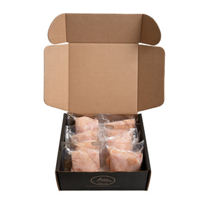  An open cardboard box displaying six vacuum-sealed packages of Joyce Farms' Poulet Rouge® Heritage Boneless Skinless Chicken Breasts. The packages are neatly arranged in two rows of three, showcasing the product's fresh and premium quality. The box has the Joyce Farms logo on the front.