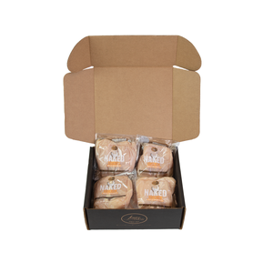 A box containing four pieces of Joyce Farms boneless skinless chicken breasts in a brown box.