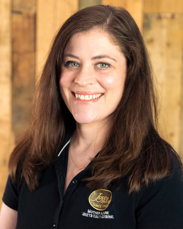 Image - headshot of Beth Hill, Joyce Farms' Marketing Manager, smiling in black shirt with Joyce Farms logo