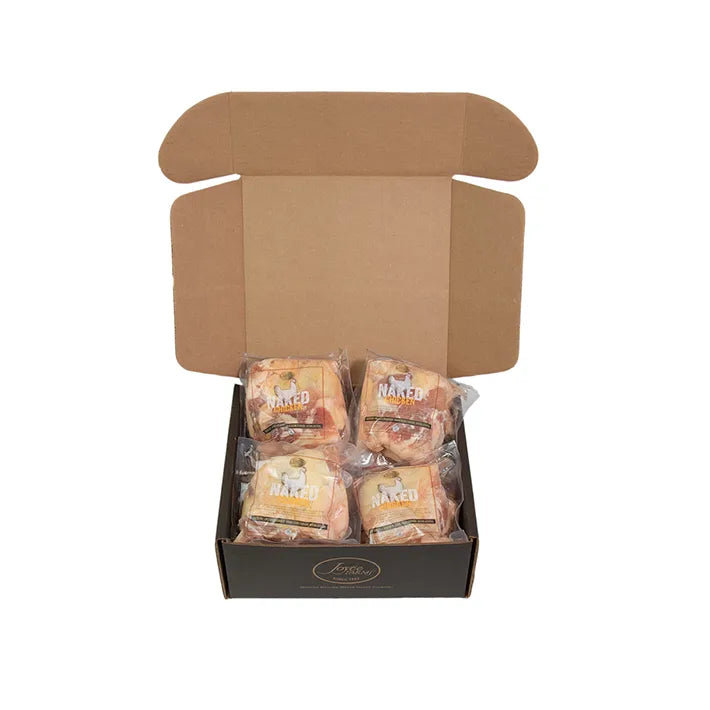 Open box with multiple packages of Antibiotic-Free Bone-In, Skin-On Naked Chicken Thighs.