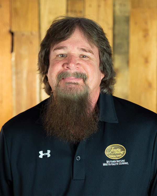 Image - headshot of Chris Campbell, Joyce Farms' Controller, smiling in black shirt with Joyce Farms logo