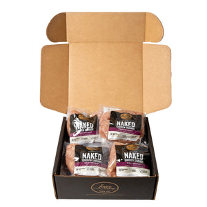 Open case showing individual packages of Joyce Farms Naked Chicken Bratwurst