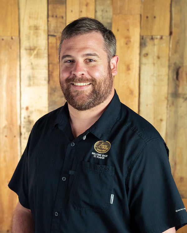 Image - headshot of Nate Morgan, Joyce Farms' Sales Manager, smiling in black shirt with Joyce Farms logo