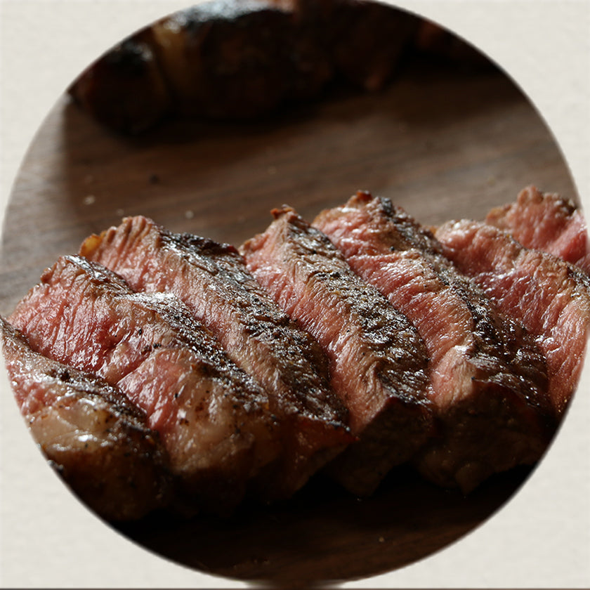 Cooked Joyce Farms Heritage Beef Steak, sliced on cutting board