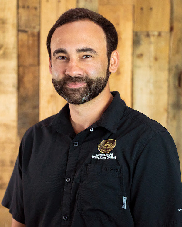 Image - headshot of Stuart Joyce, Joyce Farms' Executive Vice President, smiling in black shirt with Joyce Farms logo