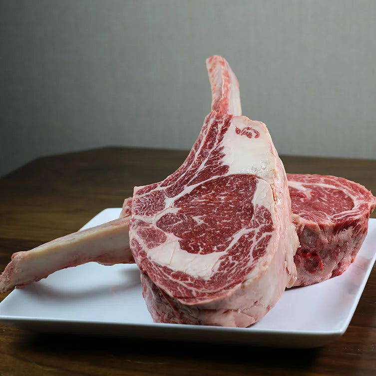 Heritage Beef Tomahawk from Joyce Farms, featuring exceptional marbling and rich flavor, naturally raised on small family farms without hormones or antibiotics.