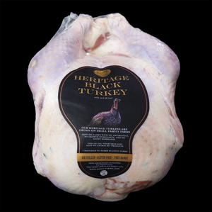 Whole Heritage Black Turkey from Joyce Farms, pasture-raised on small family farms, air-chilled, gluten-free, and free-range, packaged with neck and liver included.