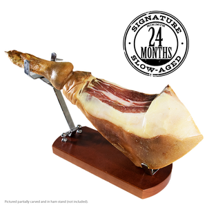 Joyce Farms Signature Cured Heritage Ham Aged Minimum 24 Months, shown partially carved in ham stand. Raised regeneratively in North Carolina, Cured in North Carolina, raised with no antibiotics, pasture raised, animal welfare approved